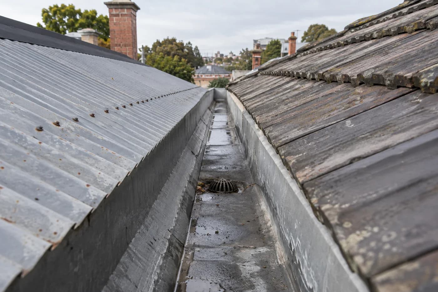 Metal box gutter between adjoining terrace roofs